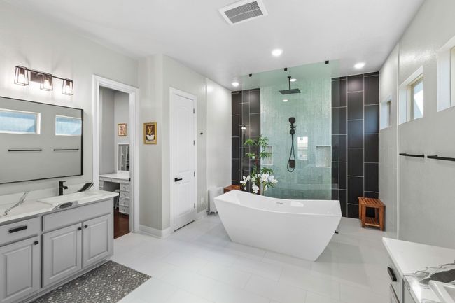 Full bath featuring vanity, a walk in shower, a soaking tub and 2 vanities | Image 23