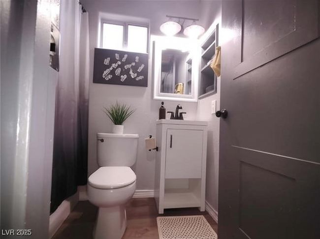 Bathroom featuring vanity, a shower with curtain, and dark wood-type flooring | Image 20