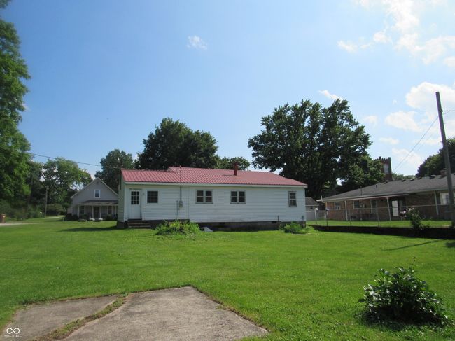 back of house featuring a metal roof and crawl space | Image 5