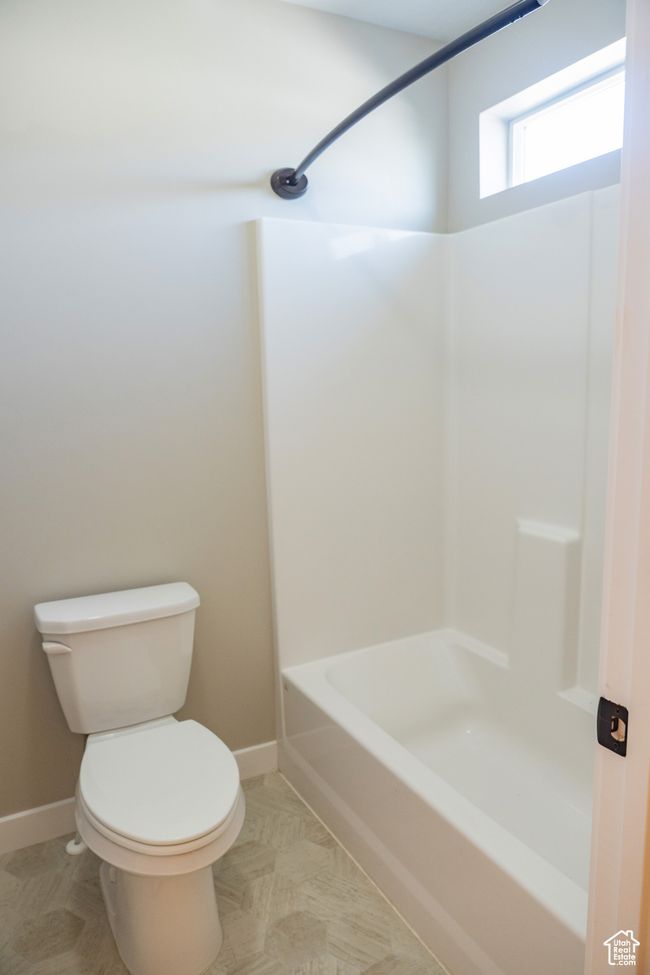 Bathroom with toilet and shower combination | Image 19