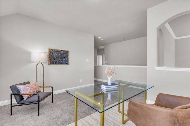 Sitting room with arched walkways, baseboards, and vaulted ceiling | Image 21