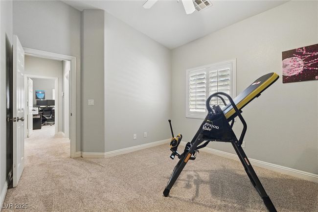 Exercise room with ceiling fan, baseboards, visible vents, and carpet | Image 26