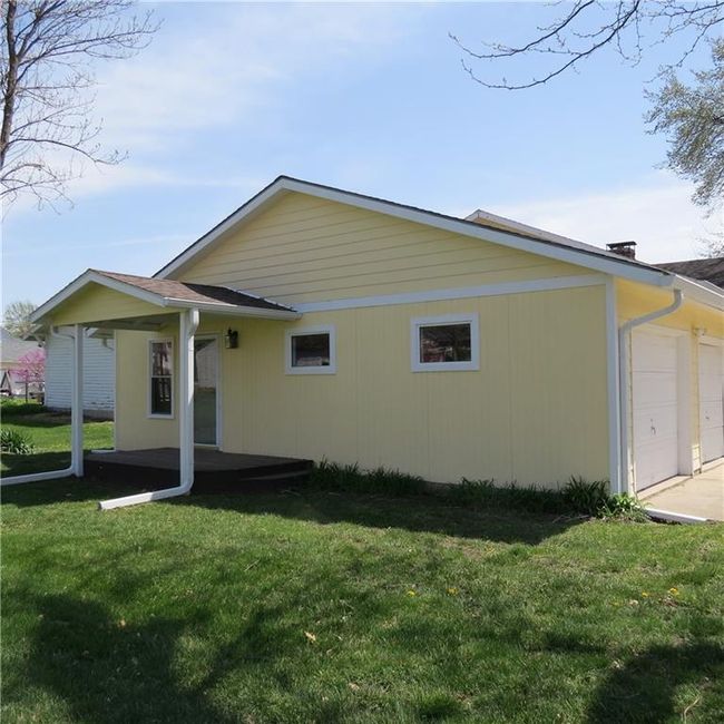 Rear view of house with a lawn right outside of primary bedroom suite | Image 4
