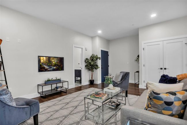 Living area with wood finished floors, recessed lighting, and baseboards | Image 6