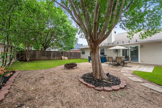 View of yard featuring a fire pit and a patio area | Image 26