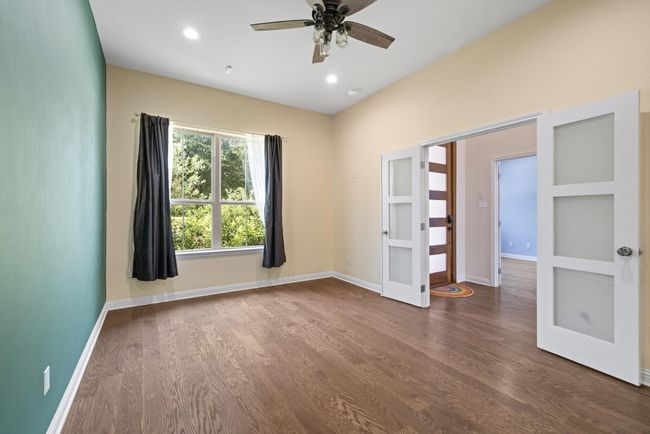 Empty room featuring french doors, wood finished floors, ceiling fan, and recessed lighting | Image 23