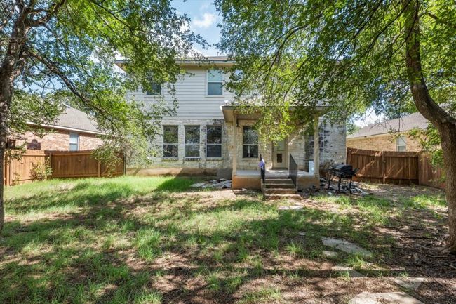 Back of property with a fenced backyard and stone siding | Image 32