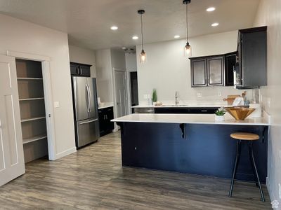 Kitchen with two pantries, a breakfast bar area, sink, stainless steel appliances, and kitchen peninsula. | Image 2