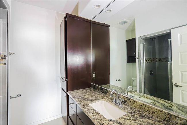 Full bathroom with a stall shower, vanity, and toilet | Image 19