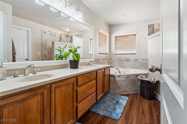 Full bath with a bath, wood finished floors, and double vanity | Image 30