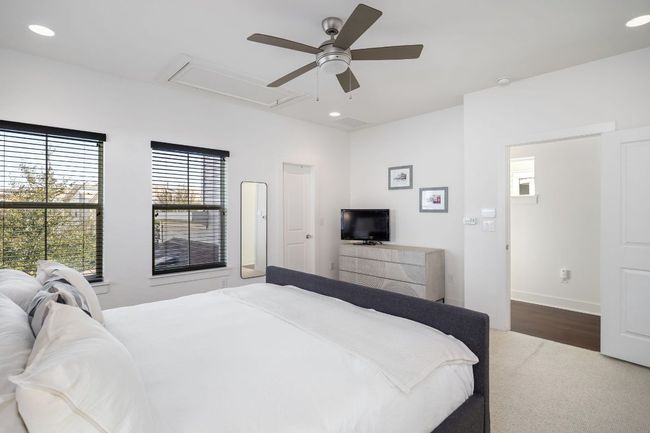 Bedroom with attic access, wood finished floors, a ceiling fan, and recessed lighting | Image 28