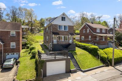 Three units up and down with a detached income garage and coin op laundry plus off street parking in rear accessed via Outlook St. | Image 3