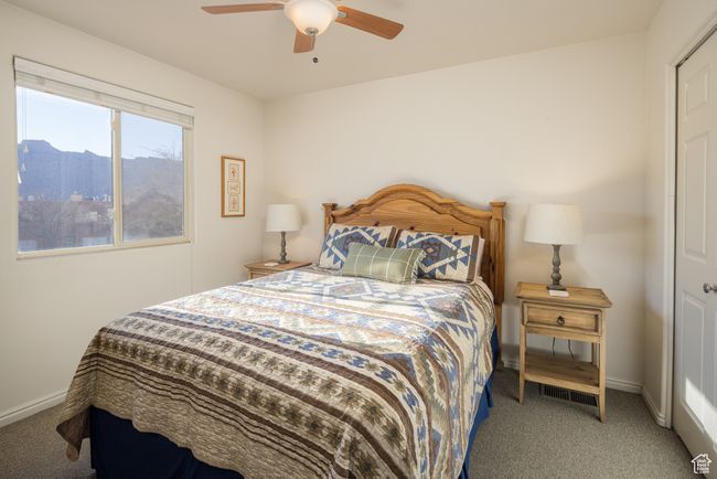 Carpeted bedroom with ceiling fan and a mountain view | Image 25