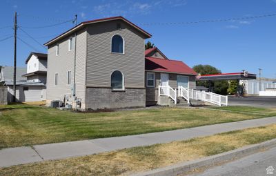 View of front of home featuring cooling unit and a front lawn | Image 2