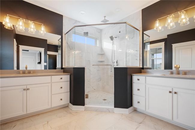 HEATED FLOORS in this luxury Owner's Suite Bathroom. 2 Separate vanities with quartz tops. Large tiled shower with rain-head and hand-held shower heads. | Image 24