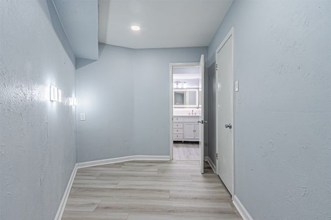 Hallway with light hardwood / wood-style flooring | Image 27