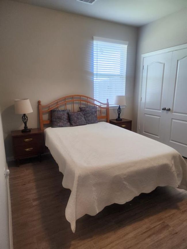 Cozy second bedroom with ample natural light and stylish decor. | Image 20