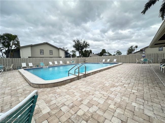 Community pool with a patio and a fenced backyard | Image 28