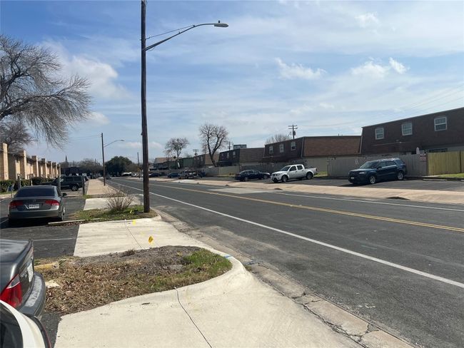 View of street with sidewalks, curbs, and street lights | Image 19