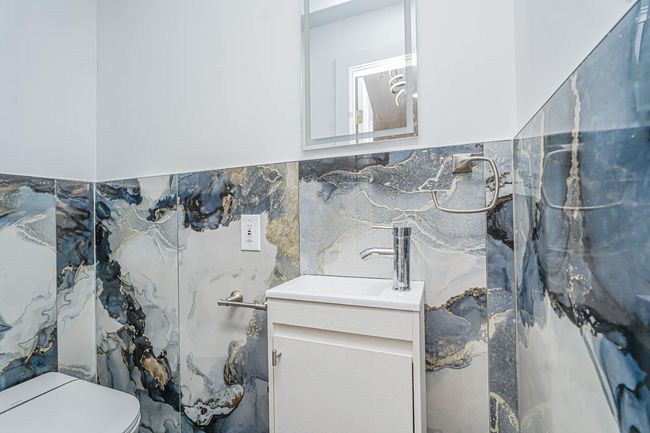 Half bathroom featuring vanity and toilet | Image 4