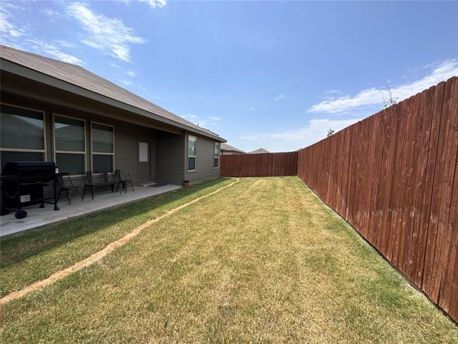Fenced backyard featuring a patio area | Image 15