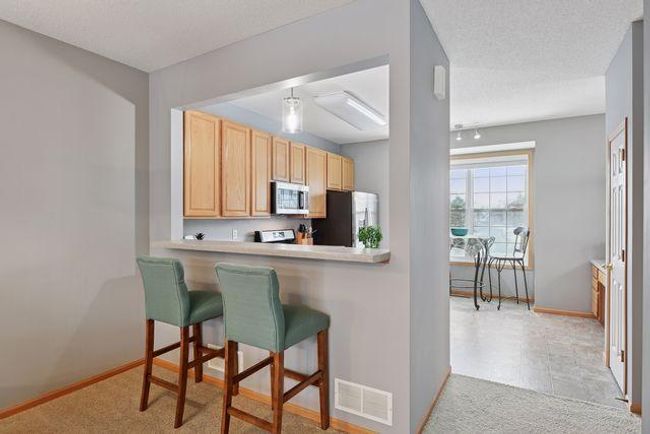 Kitchen boasts a Breakfast Bar. | Image 10