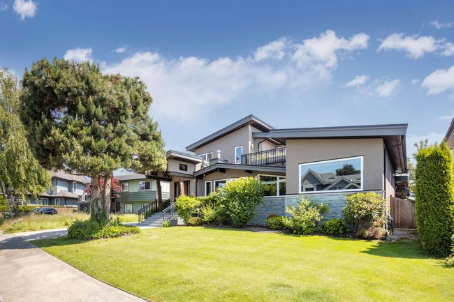 Contemporary home featuring stucco siding, a balcony, and stone siding | Image 4
