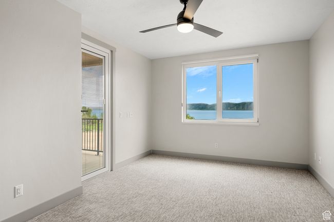 Spare room with carpet floors, baseboards, and ceiling fan | Image 14