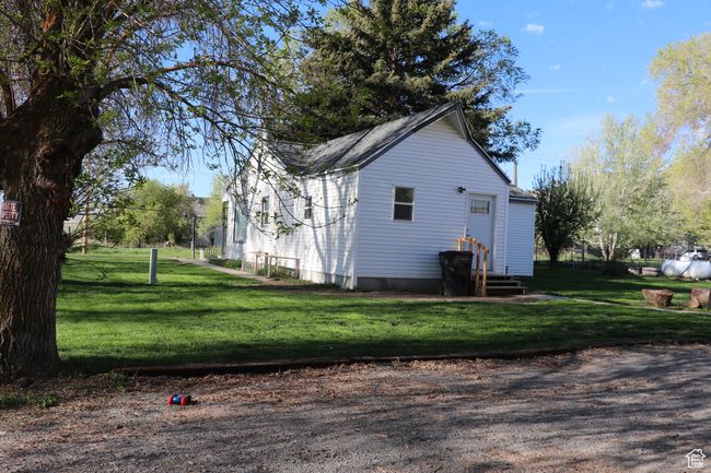 View of property exterior with a yard and entry steps | Image 42