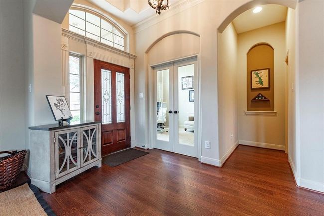 Glass panel front door at entryway. Access to study or 4th bedroom; half bath in hallway. | Image 12
