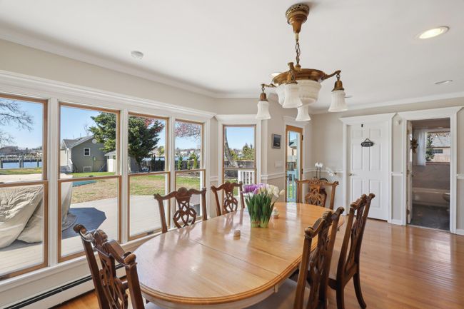 Dining area with crown molding, recessed lighting, a baseboard heating unit, and light wood-style floors | Image 12