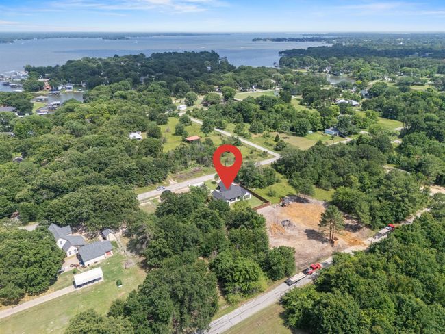 Aerial view of property and surrounding area with a large body of water and a heavily wooded area | Image 35