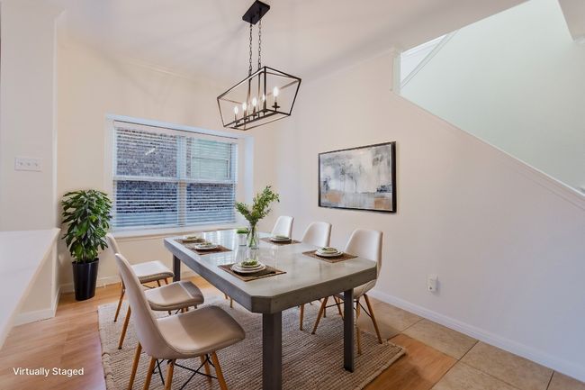 Dining room featuring a notable chandelier, baseboards, and ornamental molding | Image 9
