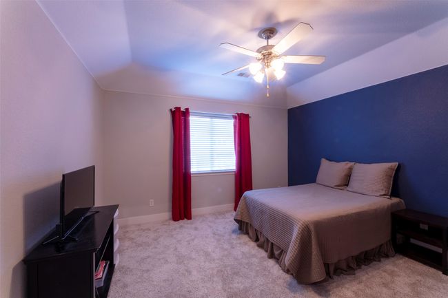 Bedroom featuring light carpet and a ceiling fan | Image 32
