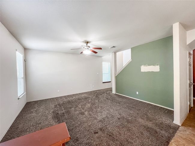 Spare room with ceiling fan and carpet floors | Image 7