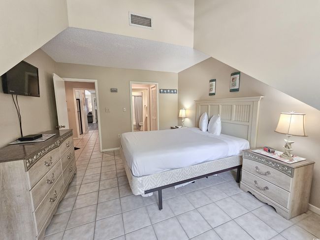 Bedroom featuring light tile patterned floors and baseboards | Image 31