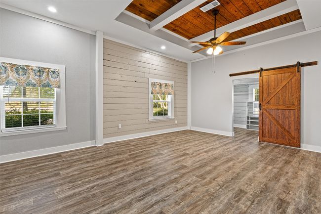 Unfurnished room with a barn door, plenty of natural light, visible vents, and wooden ceiling | Image 18