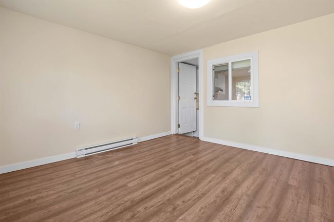 Unfurnished room with a baseboard heating unit, baseboards, and wood finished floors | Image 12