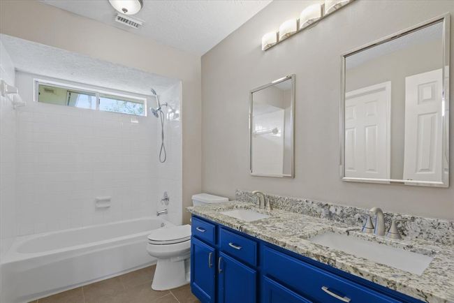Secondary bath has same classy granite as kitchen and two undermount sinks! No drop in style and grace for your guests! | Image 27