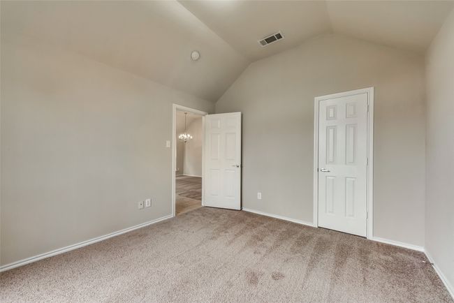 Unfurnished bedroom featuring lofted ceiling and carpet floors | Image 8