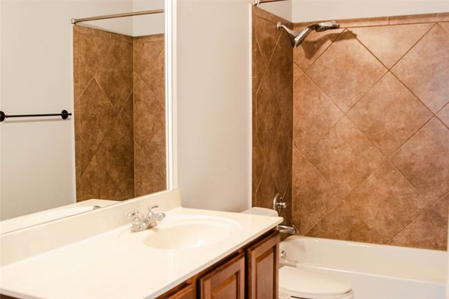 Full bath featuring vanity and shower / tub combination | Image 23