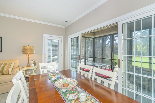 Dining area with plenty of natural light and ornamental molding | Image 7