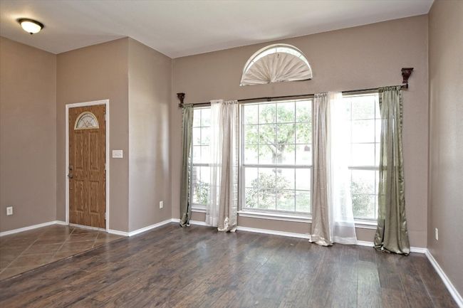 Entryway featuring dark wood finished floors and baseboards | Image 4