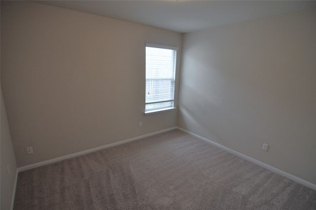 Empty room featuring light colored carpet and baseboards | Image 9