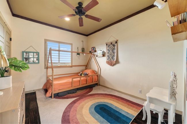 Bedroom featuring carpet flooring, ceiling fan, baseboards, and ornamental molding | Image 24