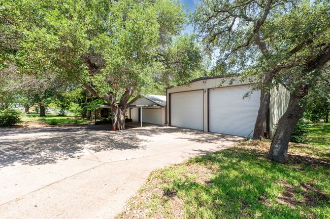 View of front of property featuring a garage and an outbuilding | Image 5