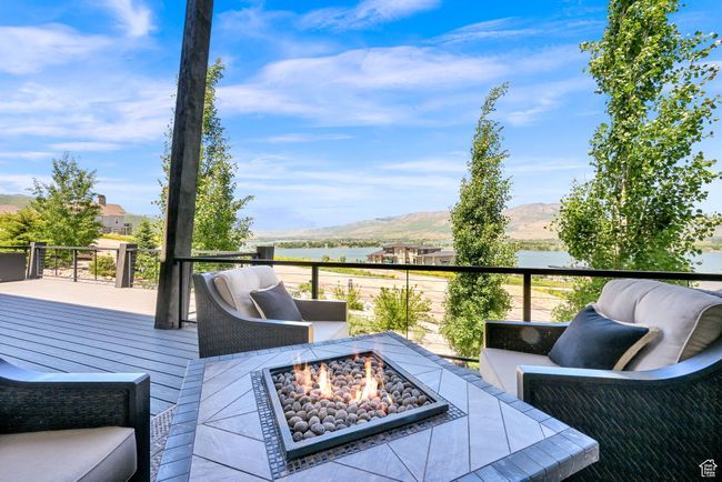 Deck with a fire pit and a water and mountain view | Image 82