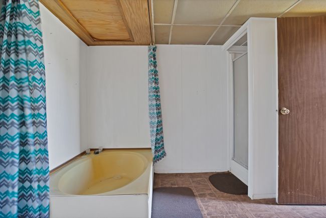 Bathroom with a stall shower and a garden tub | Image 16