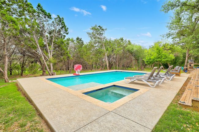 Outdoor pool featuring an in ground hot tub and a patio area | Image 34