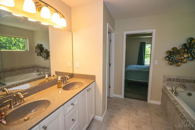 Garden Bath with double vanity, soaking tub and walk-in shower. Ceramic tile flooring throughout. | Image 24